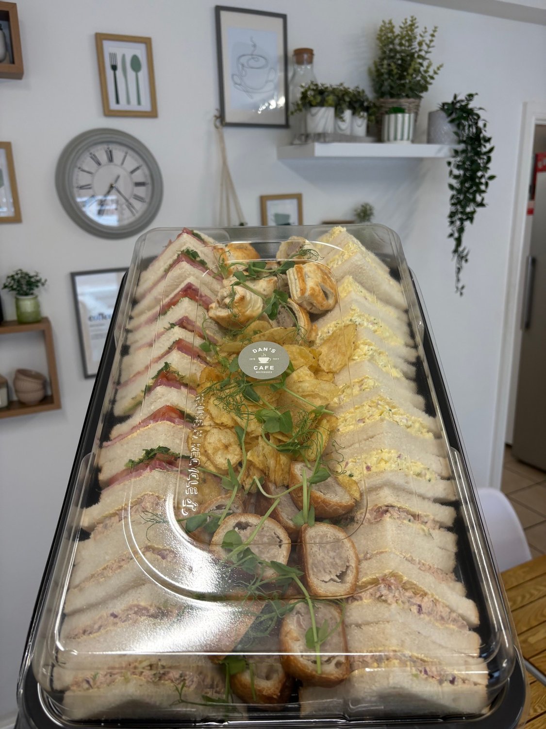 A Dan's Cafe sandwich platter with sandwiches, sausage rolls, pork pies and crisps